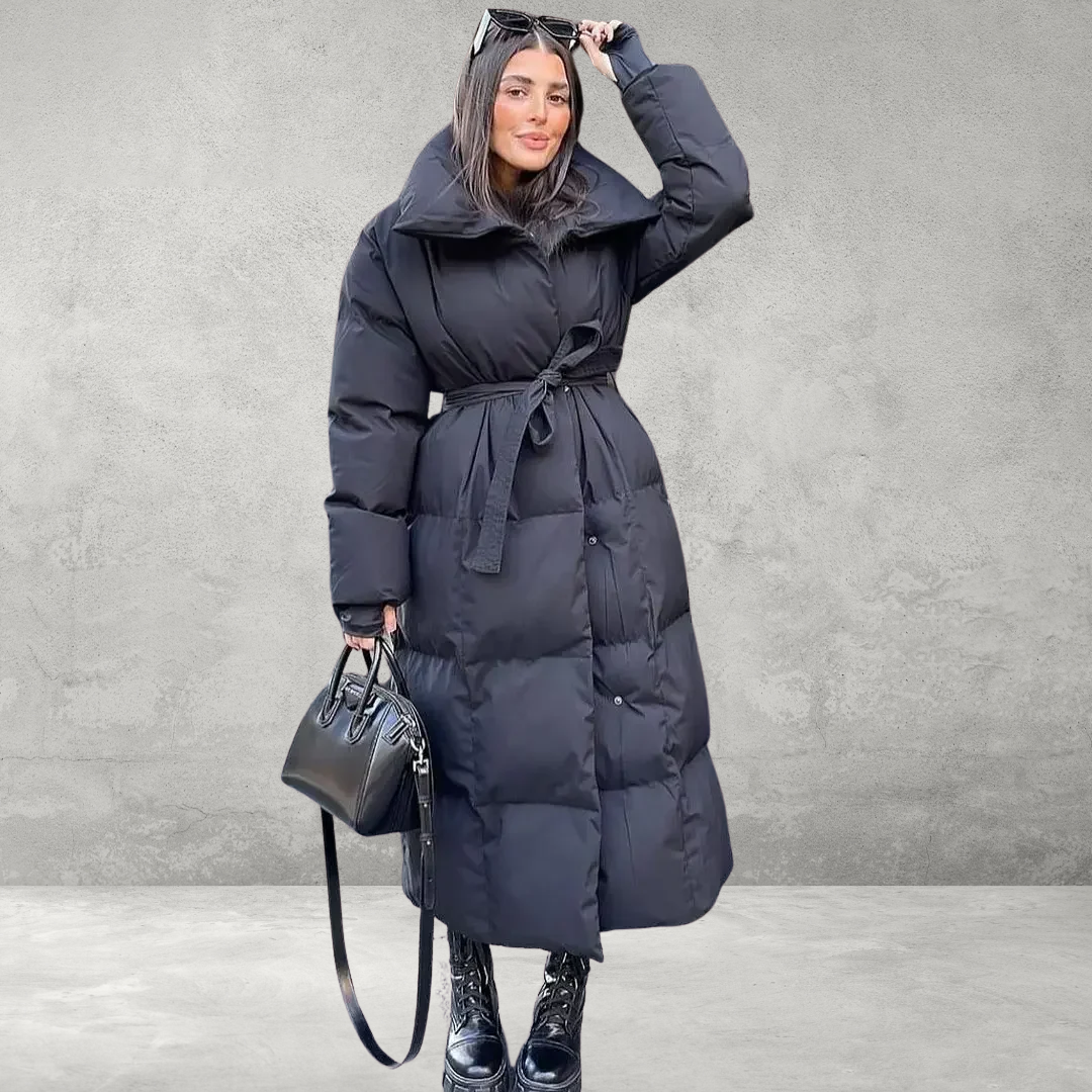 Model wearing navy padded winter coat, seated pose