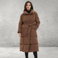 Woman wearing brown padded winter coat with tie belt