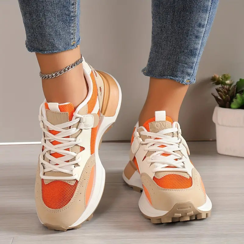 Model wearing white and orange sneakers, close-up