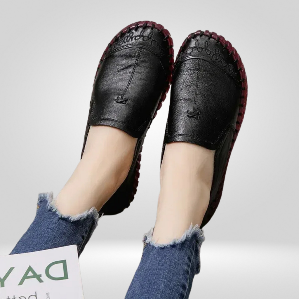 Model wearing black leather loafer, close-up