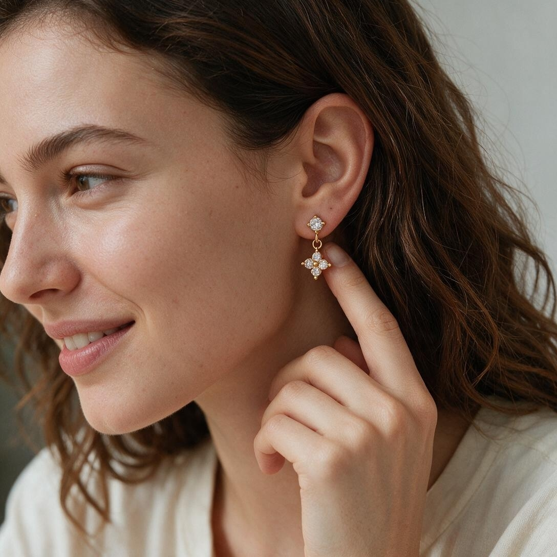 Woman wearing gold-tone CZ flower dangle earrings, lifestyle portrait