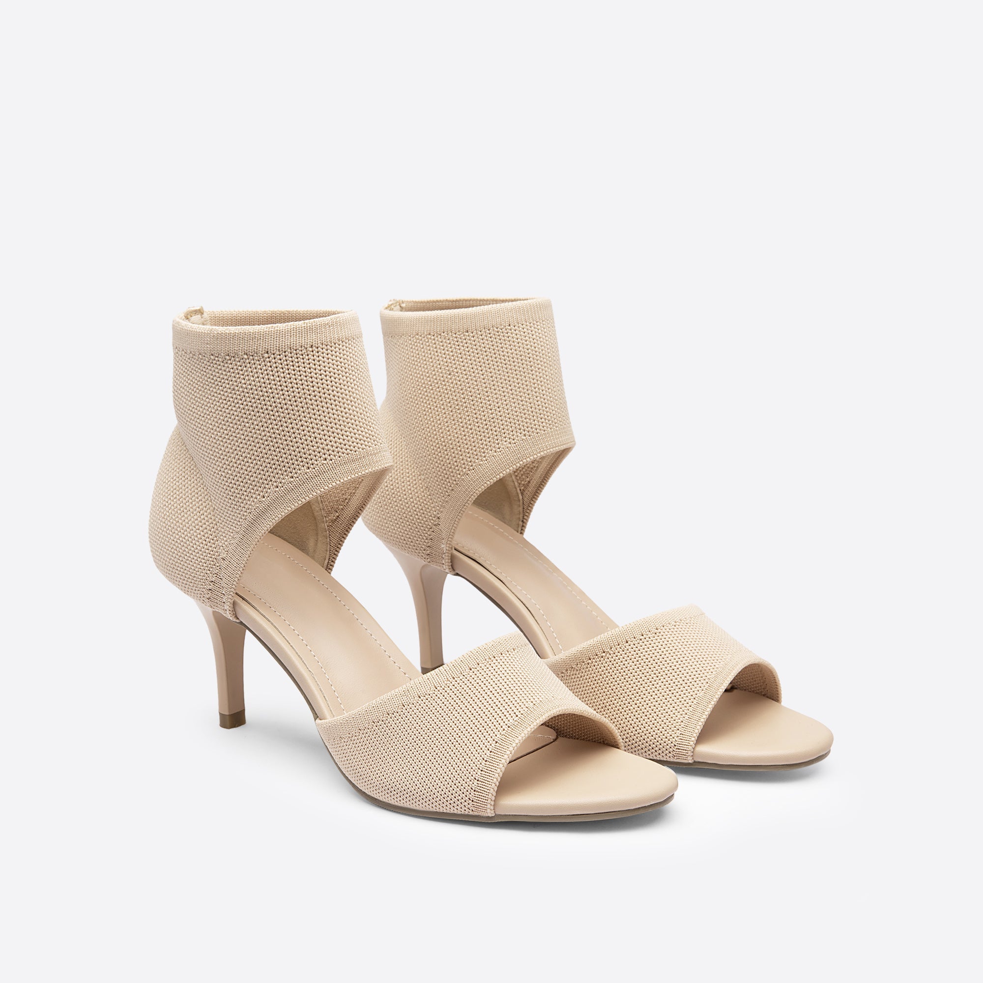 Beige stiletto ankle strap sandals, pair front view