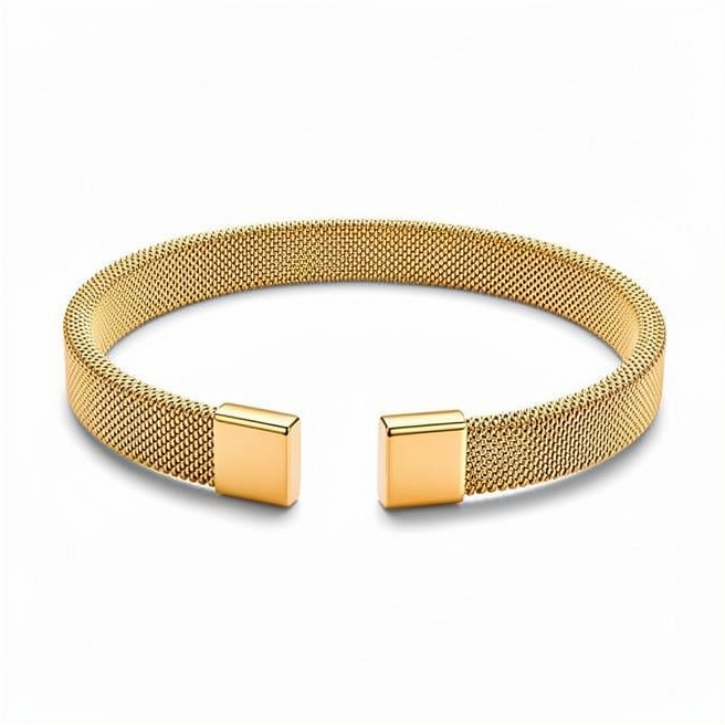 Gold-tone mesh bracelet with open cuff design and square terminals on white studio background