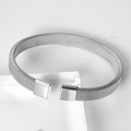 Silver-tone mesh bracelet with open cuff design and square terminals on white studio background
