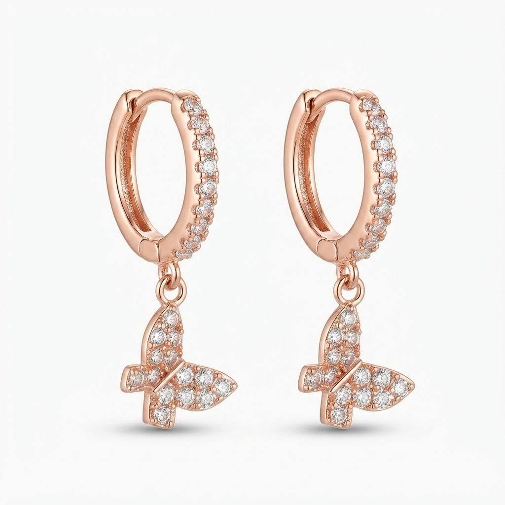 Rose gold-toned huggie hoop earrings with pavé crystal stones and dangling butterfly charm - elegant small hinged hoop earrings with crystal butterfly pendant - jewelry product photo