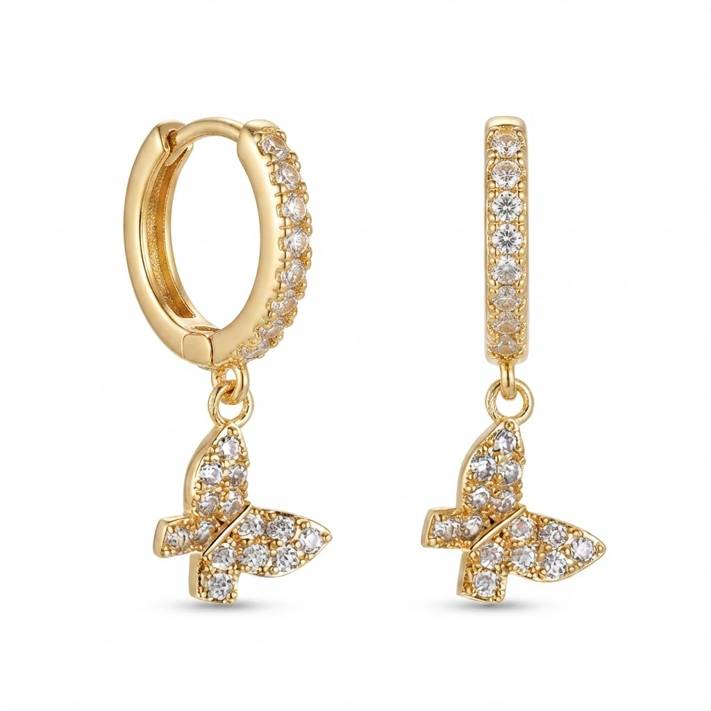 Gold-toned huggie hoop earrings with pavé crystal stones and dangling butterfly charm - elegant small hinged hoop earrings with crystal butterfly pendant - jewelry product photo