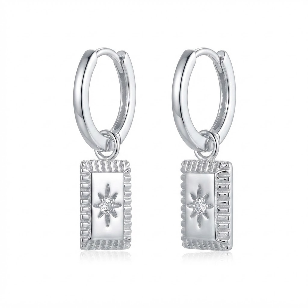 Silver-toned huggie hoop earrings with rectangular star medallion pendant - elegant small hoop earrings with textured frame and crystal starburst charm - jewelry product photo