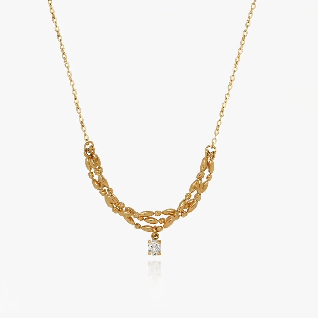 Gold-toned double oval chain necklace with crystal pendant detail - luxury layered link necklace with square crystal charm - close-up product photography
