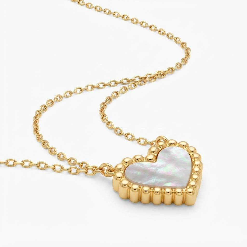 Gold-toned delicate chain necklace with iridescent mother-of-pearl heart pendant – elegant adjustable necklace with pearlescent heart charm and beaded gold border – jewelry product photo
