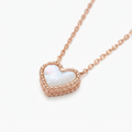 Rose gold-toned delicate chain necklace with iridescent mother-of-pearl heart pendant – elegant adjustable necklace with pearlescent heart charm and beaded rose gold border – jewelry product photo