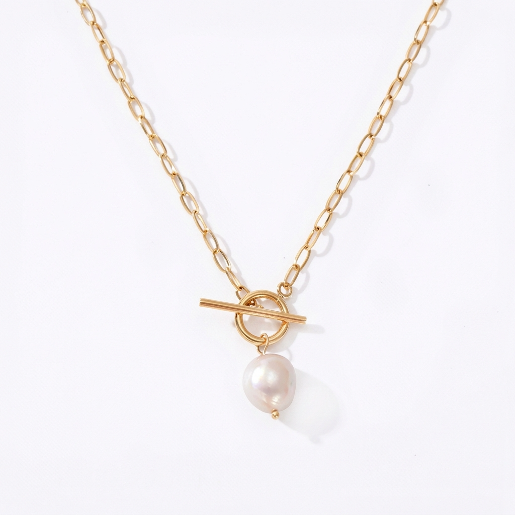 Gold-toned necklace with faux pearl detail - luxury necklace with square crystal stone and gold-colored chain - close-up product photography