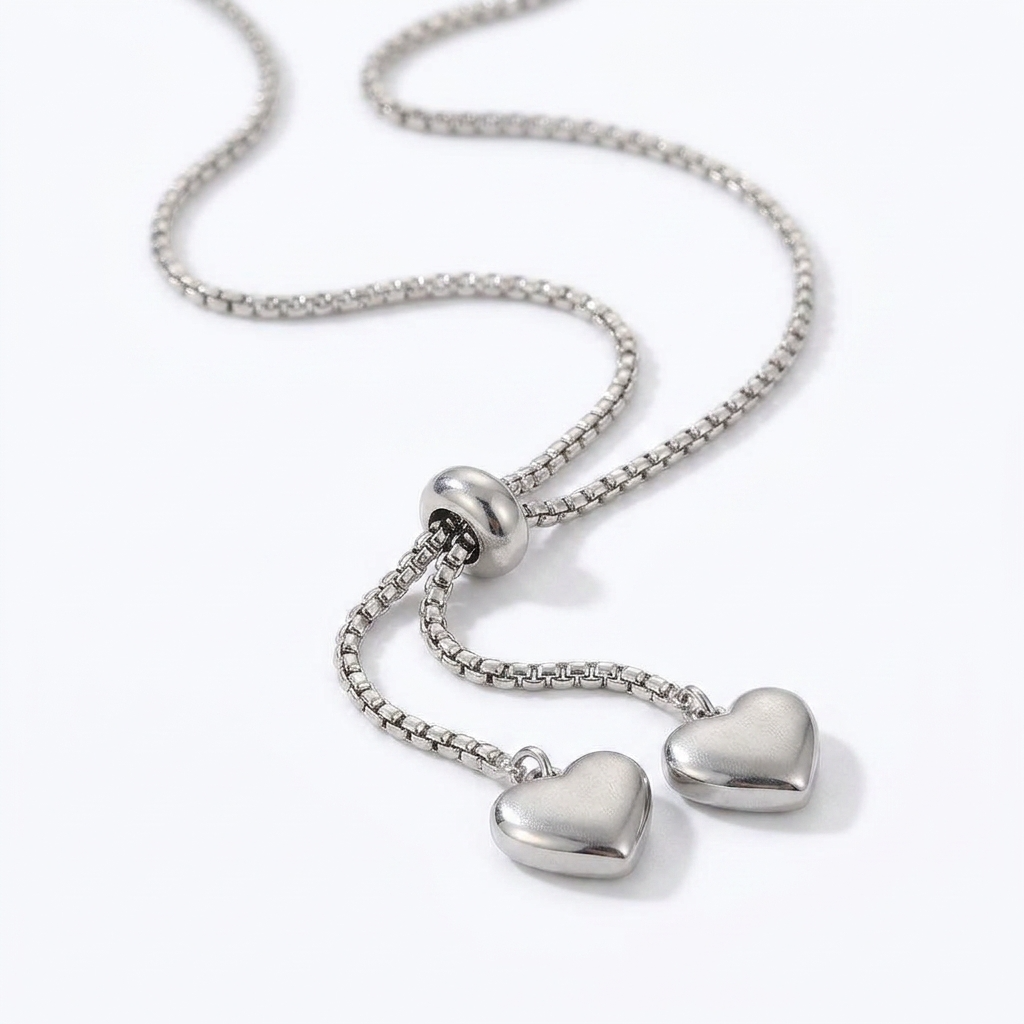 Silver-toned adjustable bolo necklace with heart-shaped charms - elegant slider necklace with double heart pendants - jewelry product photo