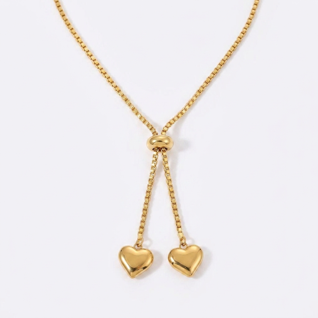 Gold-toned adjustable bolo necklace with heart-shaped charms - elegant slider necklace with double heart pendants - jewelry product photo
