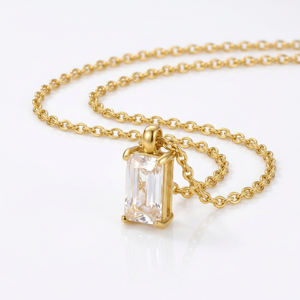 Gold-toned cable chain necklace pendant detail - luxury necklace with vertical rectangular crystal stone - close-up product photography
