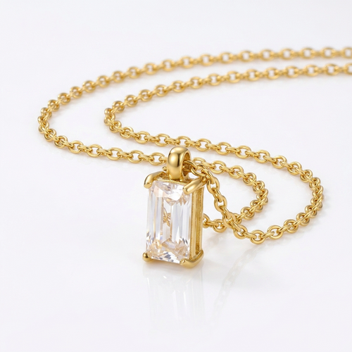 Gold-toned cable chain necklace pendant detail - luxury necklace with vertical rectangular crystal stone - close-up product photography
