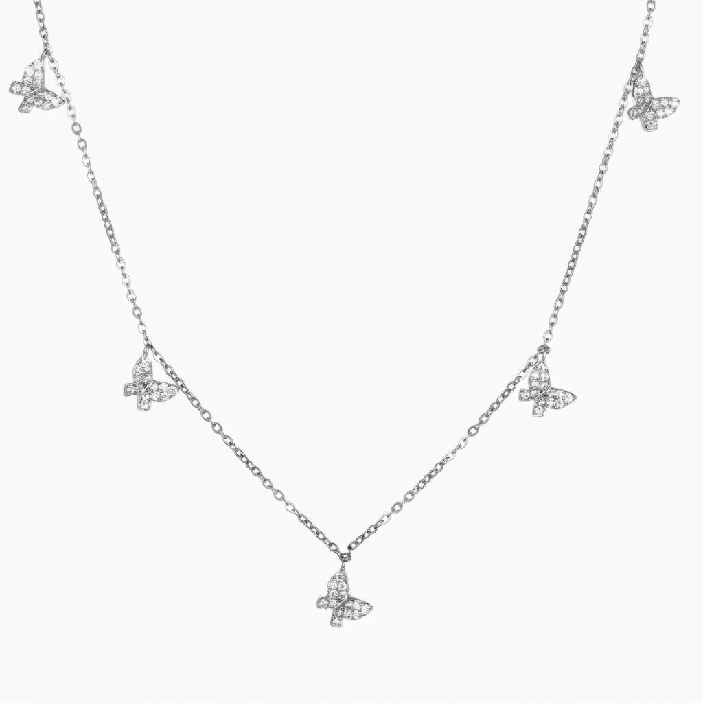 Silver-toned butterfly necklace with crystal accents detail - luxury station necklace with five butterfly charms - close-up product photography
