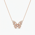Rose gold-toned butterfly pendant necklace with crystal accents detail - luxury necklace with dimensional butterfly charm - close-up product photography
