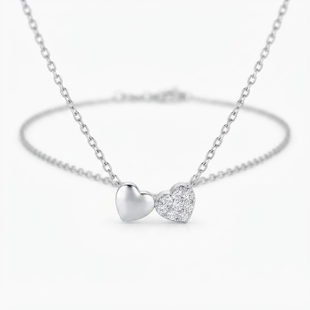 Silver-toned double heart necklace detail - luxury necklace with solid and crystal-encrusted heart charms - close-up product photography
