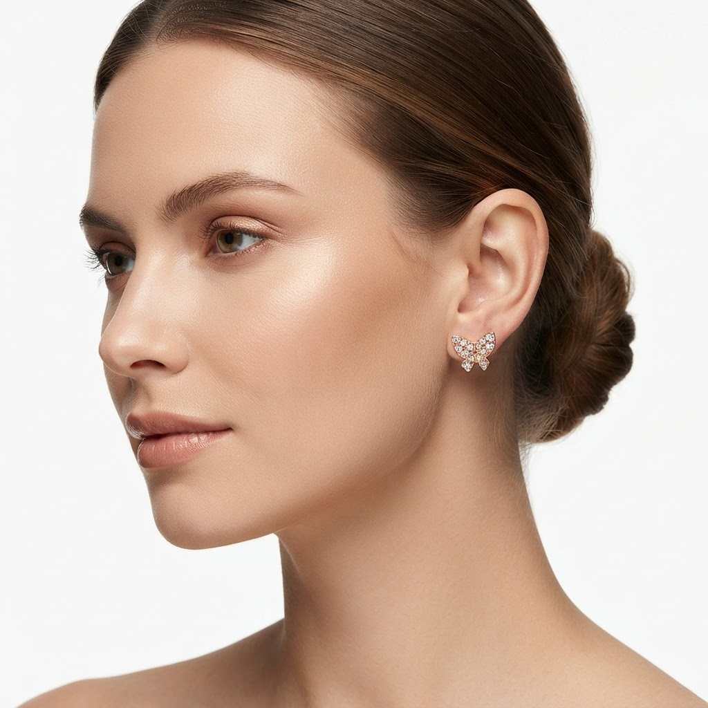 Woman wearing rose gold-toned crystal butterfly stud earrings - elegant pavé butterfly earrings styling photo - luxury jewelry lifestyle photography