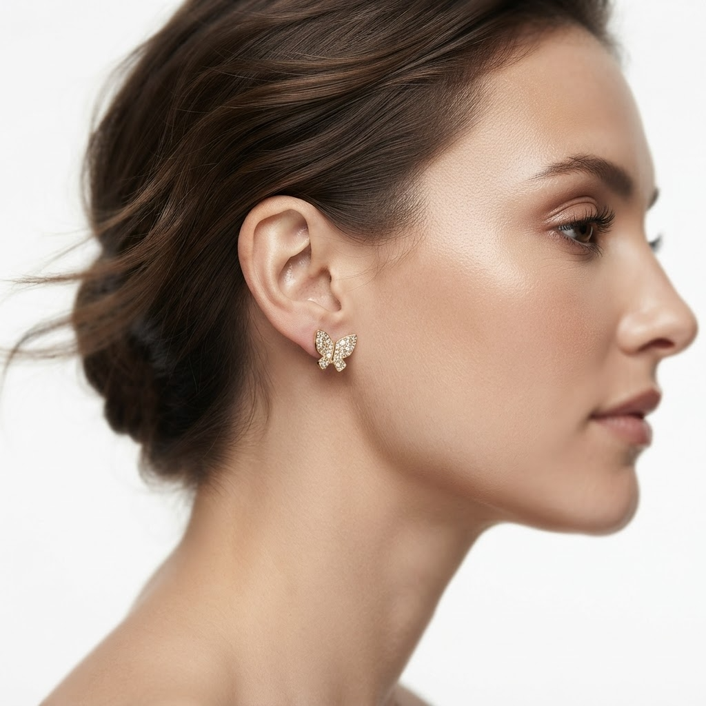 Woman wearing gold-toned crystal butterfly stud earrings - elegant pavé butterfly earrings styling photo - luxury jewelry lifestyle photography