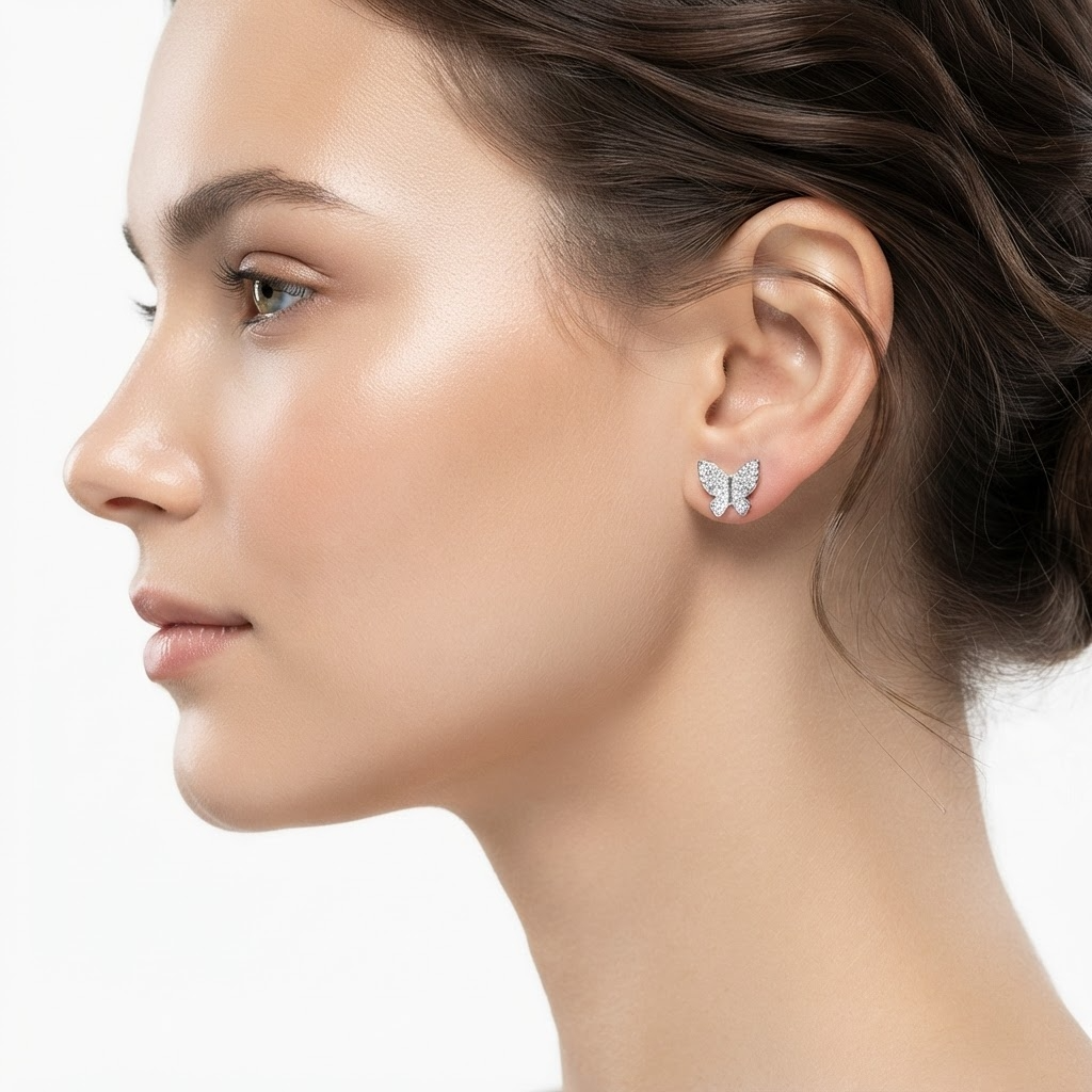 Woman wearing silver-toned crystal butterfly stud earrings - elegant pavé butterfly earrings styling photo - luxury jewelry lifestyle photography