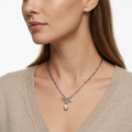 Woman wearing silver-toned paperclip chain necklace with toggle clasp and faux pearl pendant - elegant necklace styling photo - luxury jewelry lifestyle photography