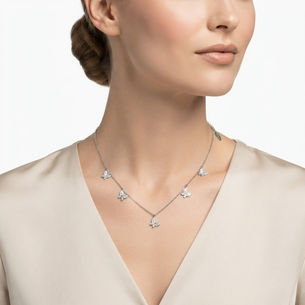 Woman wearing silver-toned chain necklace with crystal butterfly charms - elegant butterfly station necklace styling photo - luxury jewelry lifestyle photography
