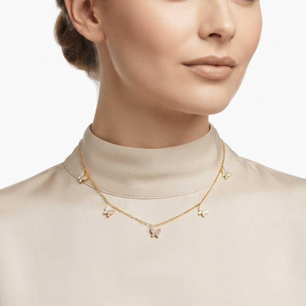 Woman wearing gold-toned chain necklace with crystal butterfly charms - elegant butterfly station necklace styling photo - luxury jewelry lifestyle photography
