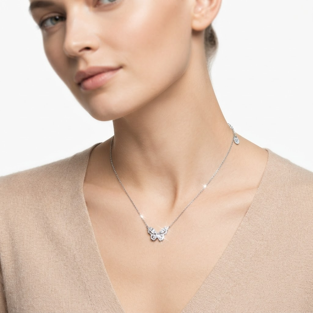 Woman wearing silver-toned chain necklace with large crystal butterfly pendant - elegant butterfly necklace styling photo - luxury jewelry lifestyle photography
