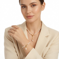 Woman wearing faux pearl necklace and bracelet set with gold-toned accents - elegant matching pearl jewelry set styling photo - luxury jewelry lifestyle photography
