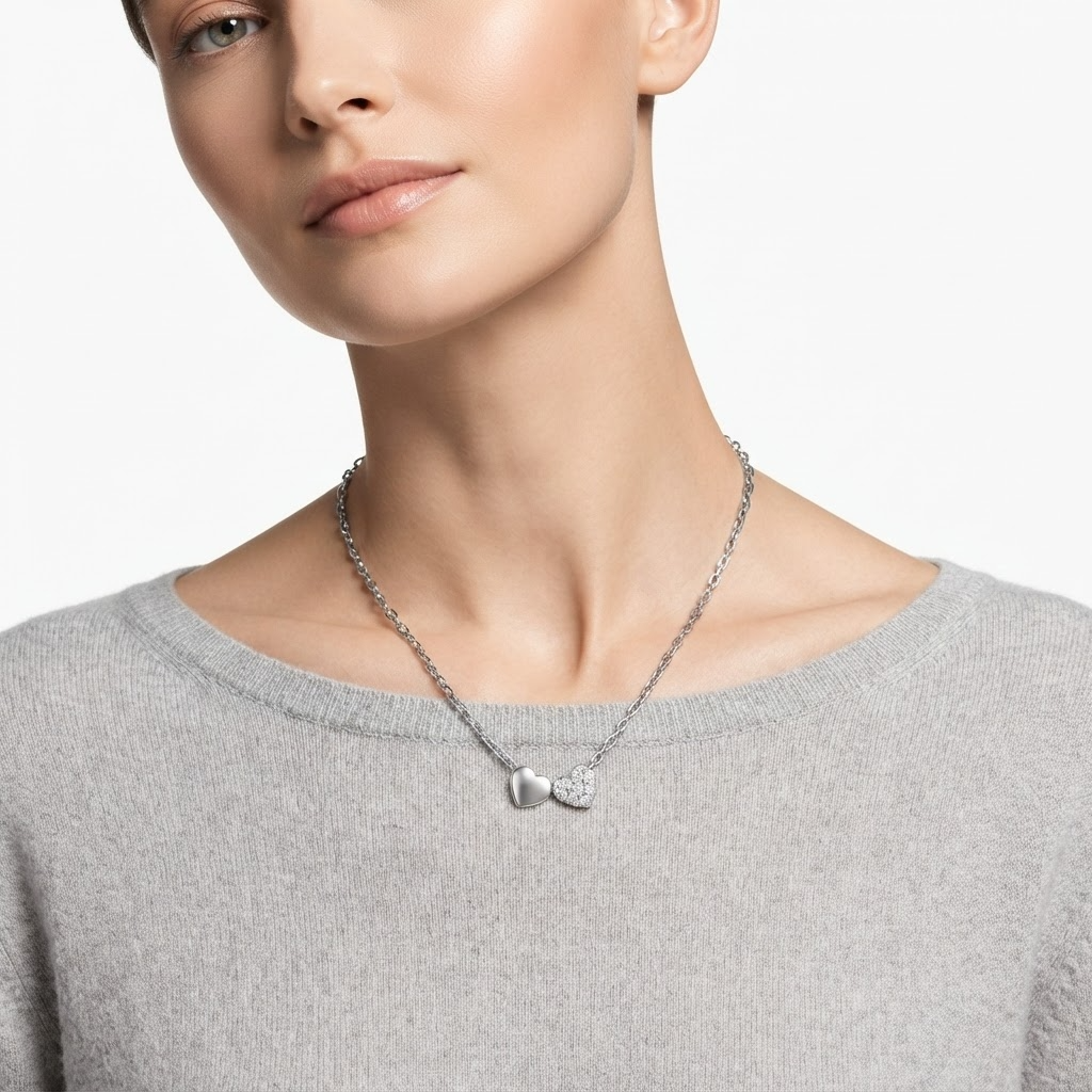 Woman wearing silver-toned chain necklace with double heart pendant - elegant romantic heart necklace styling photo - luxury jewelry lifestyle photography
