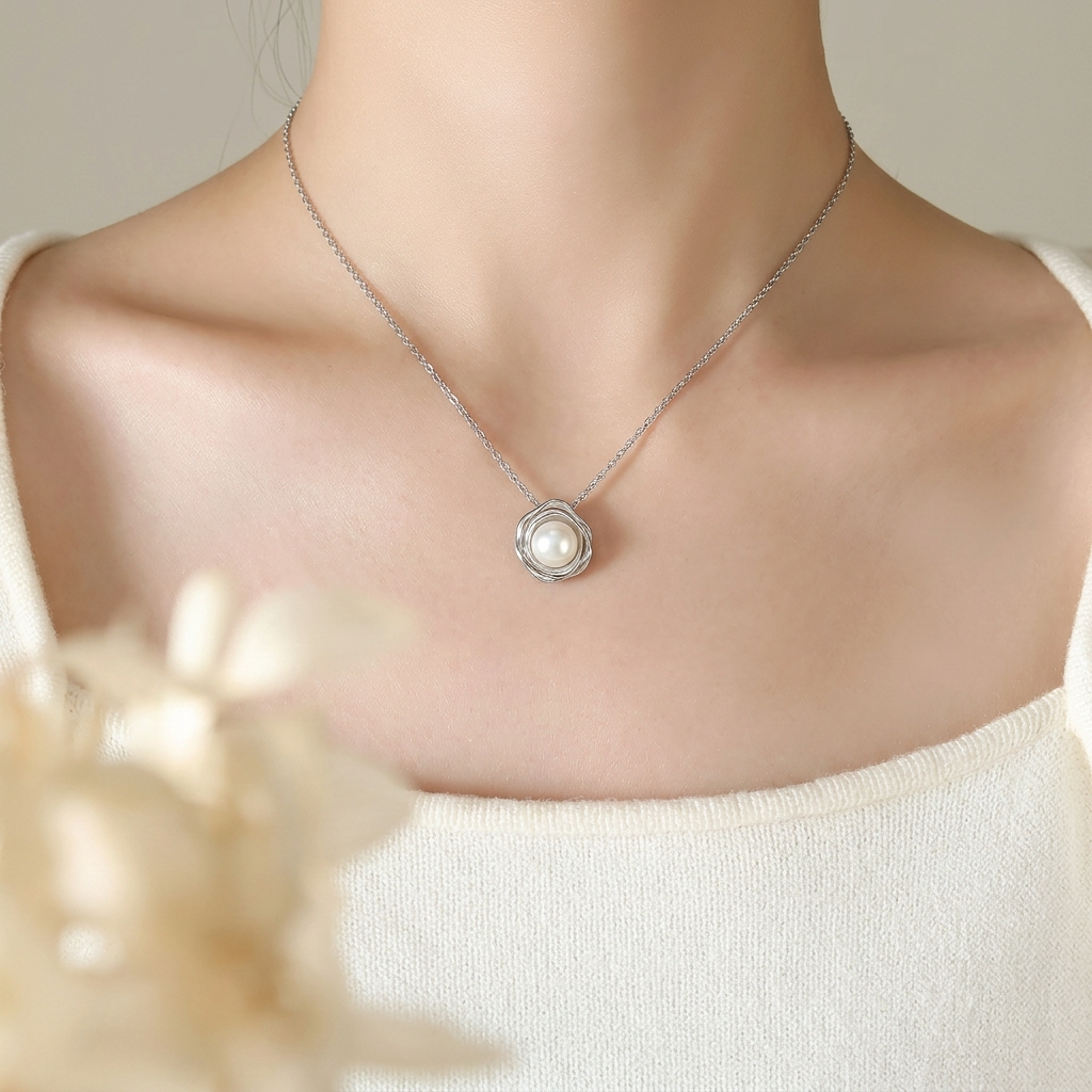 Woman wearing dainty faux pearl flower pendant necklace in silver – Velara