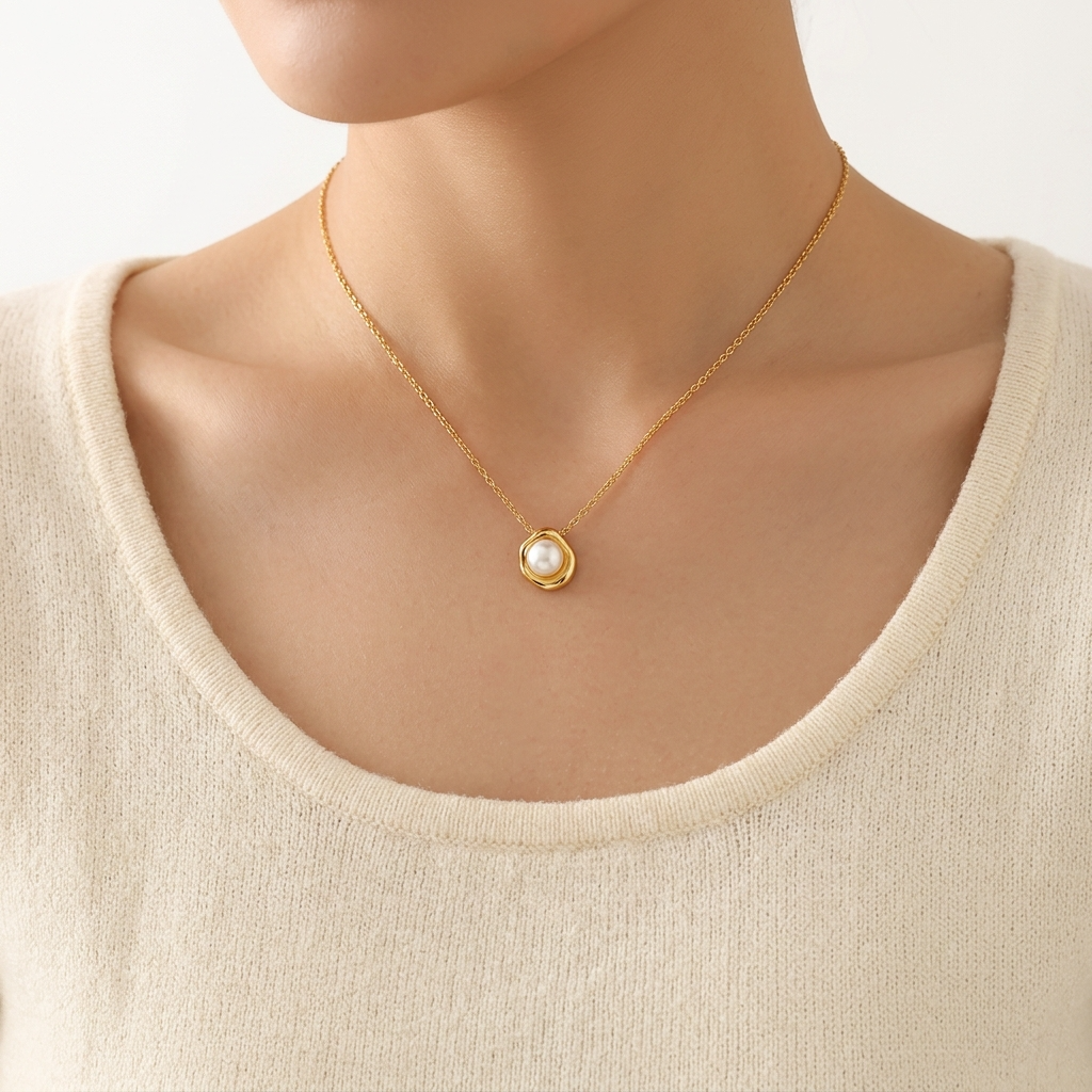 Woman wearing dainty faux pearl flower pendant necklace in gold – Velara