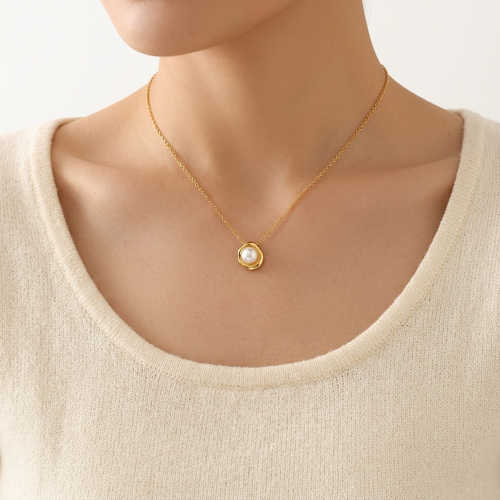 Woman wearing dainty faux pearl flower pendant necklace in gold – Velara