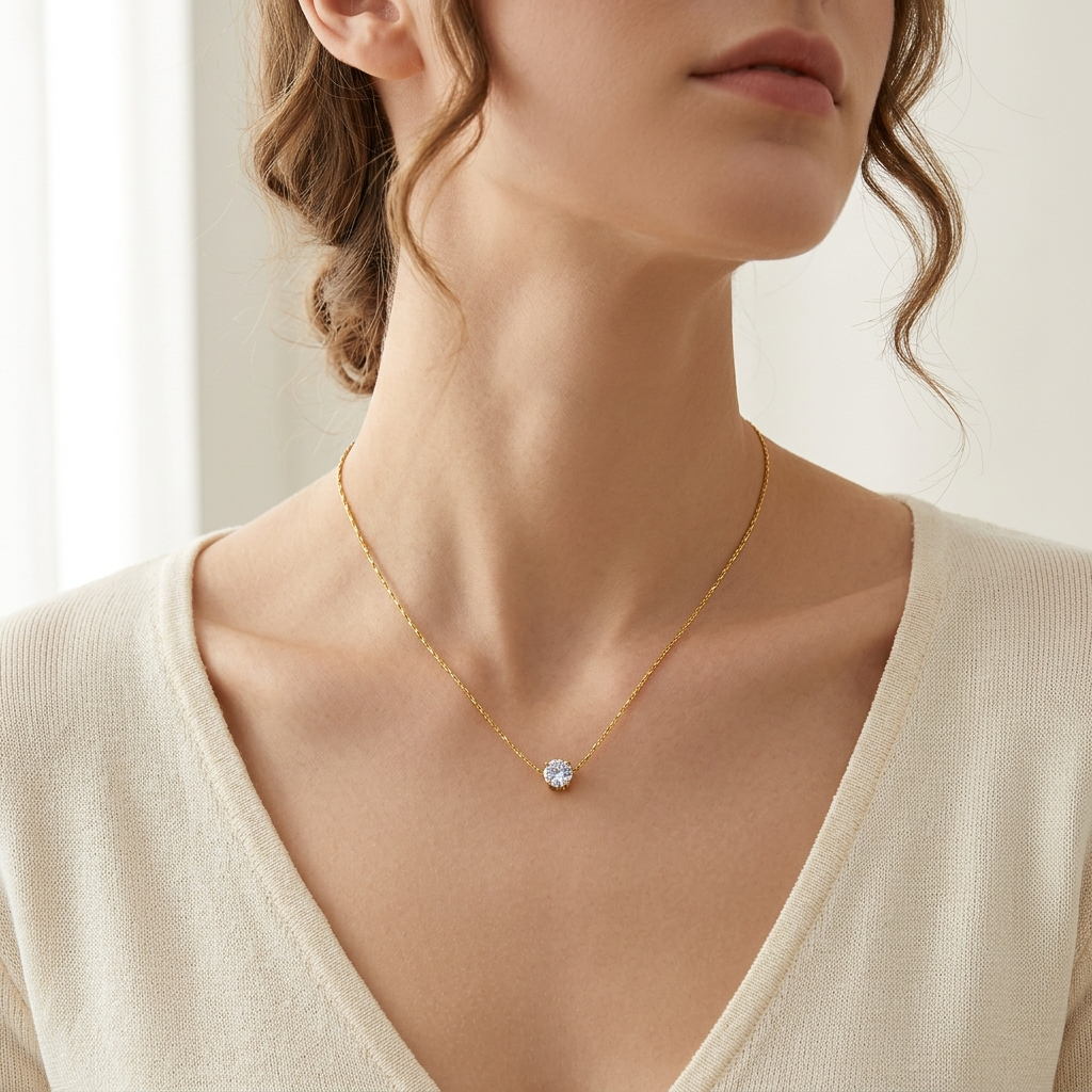Dainty round cut zirconia pendant necklace in gold color stainless steel – Velara-model wearing