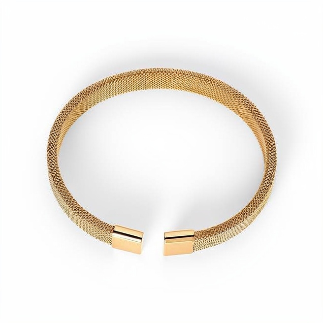 Gold-tone mesh cuff bracelet with fine woven metal texture on white background