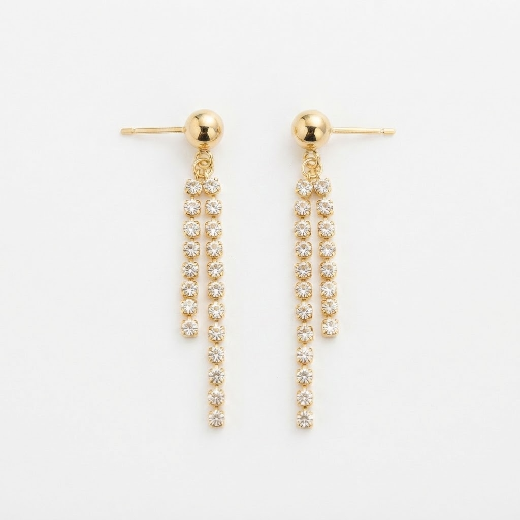Gold-toned ball stud earrings with crystal fringe detail - luxury earrings with dual tapered crystal chains - close-up product photography