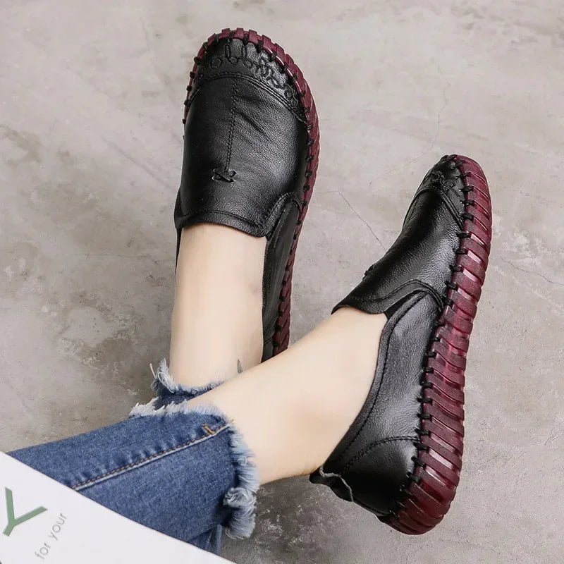 Model wearing black leather loafers with jeans