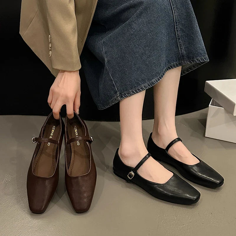 Model wearing brown low heel mules, close-up