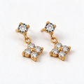Gold-tone stud earrings with four-petal flower dangle set with small clear crystals around a center bead, studio pair on white