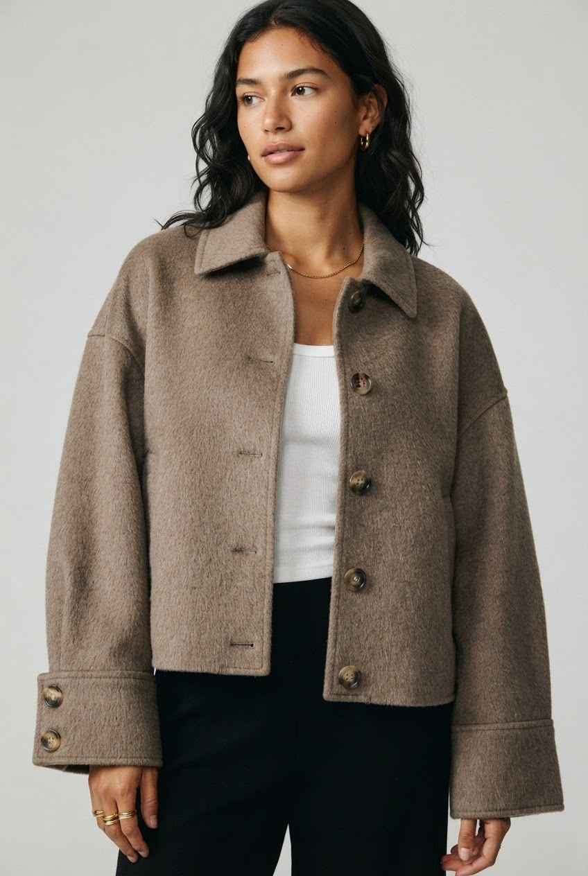 Oversized taupe wool jacket with dropped shoulders and hip length cropped fit studio side profile - Velara UK