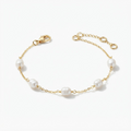 gold-toned pearl bracelet detail – 5mm baroque freshwater pearl wire-wrapped on rectangular cable chain – extreme close-up product photography