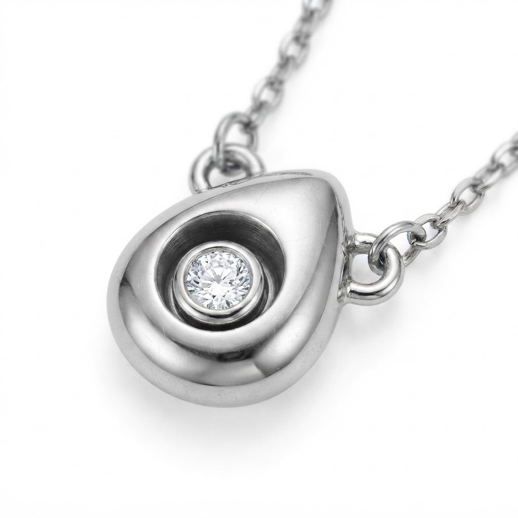 Silver-toned delicate necklace with 3D puffy teardrop pendant – premium stainless steel minimalist necklace with 7mm organic droplet charm and rotating bezel-set crystal that moves freely – luxury jewelry product photo