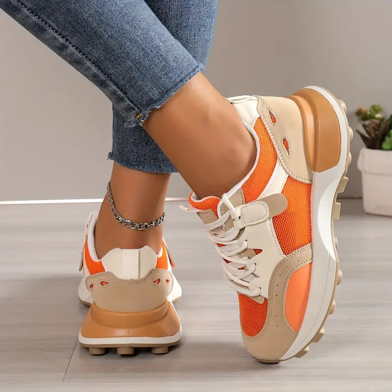 Model wearing orange sneakers, side angle