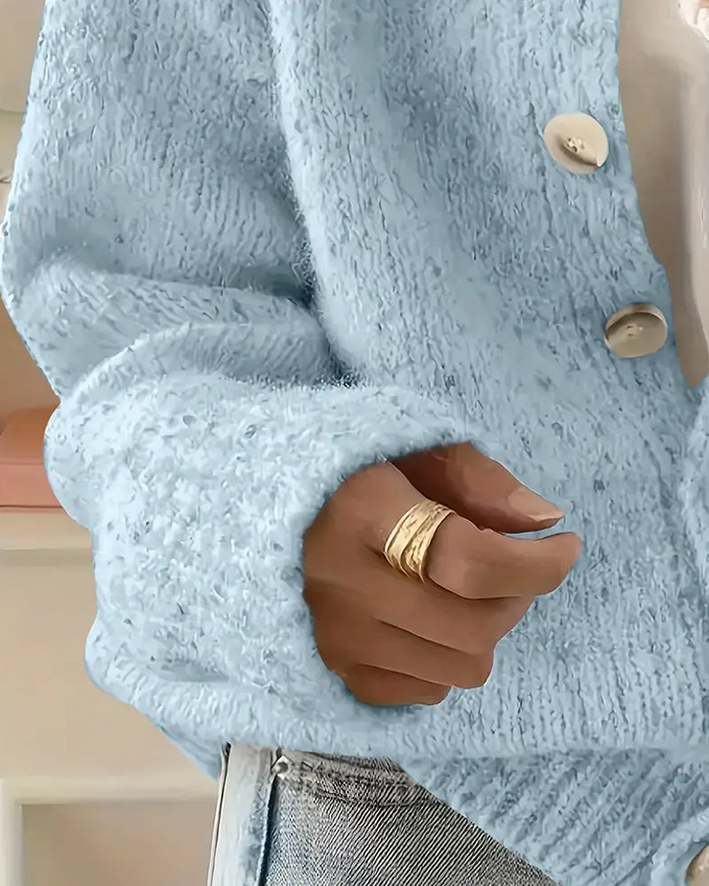 Blue knitted cardigan worn open