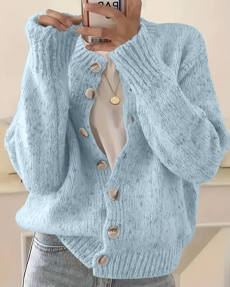 Blue knitted cardigan fabric texture close-up