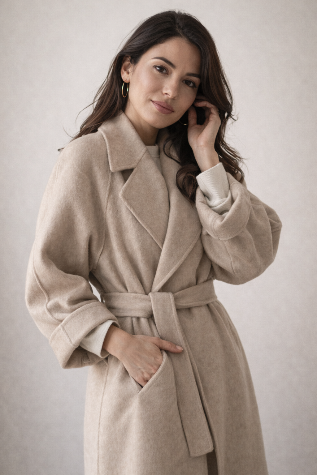 Belted coat worn open