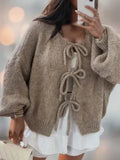Loose knit cardigan with bow tie fastening front view