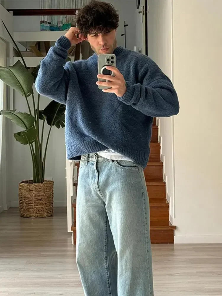 Man wearing blue knit jumper
