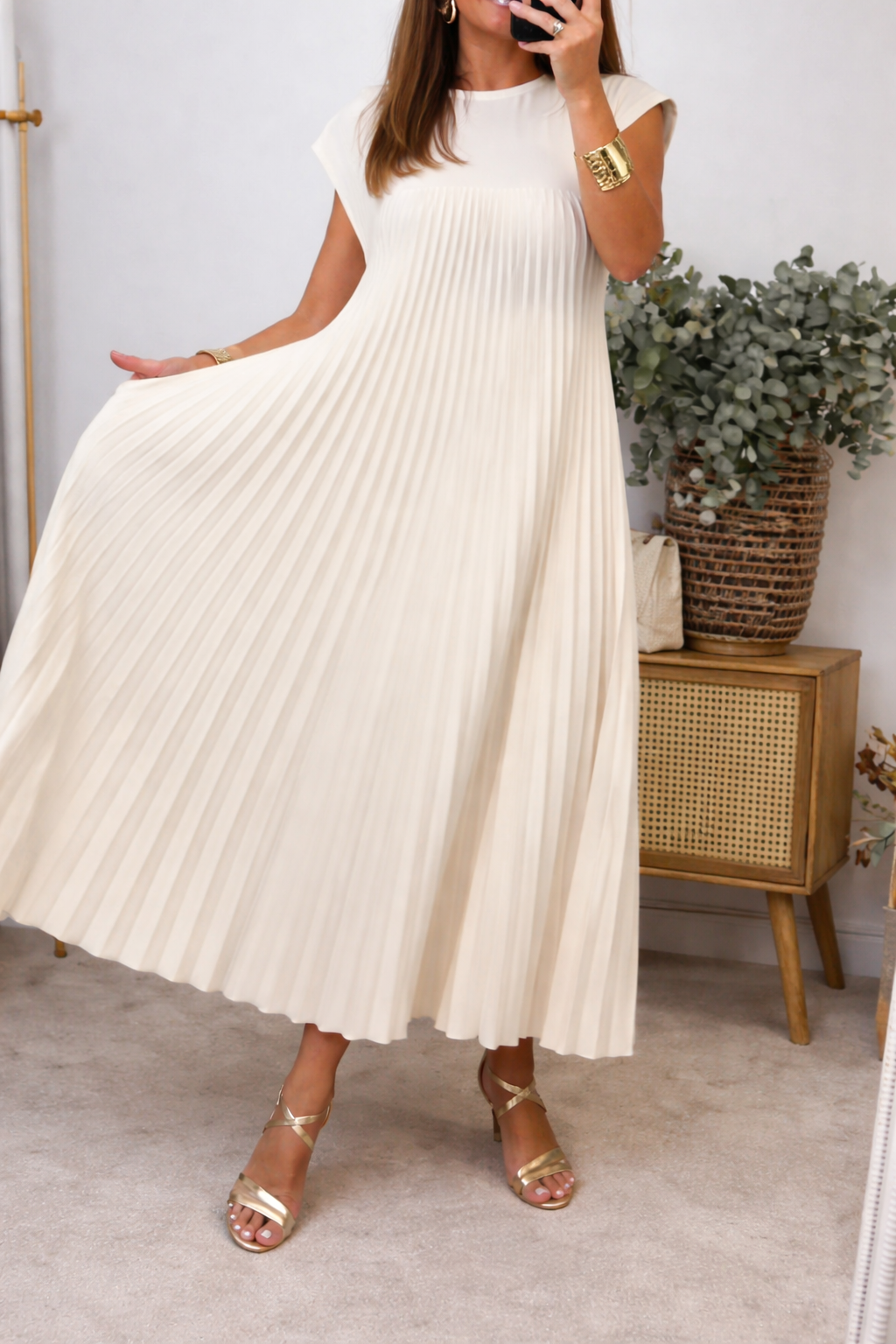 Pleated dress side view showing flowing skirt